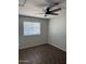 This bedroom offers a ceiling fan and a window for a comfortable and functional living space at 3006 W Stella Ln, Phoenix, AZ 85017