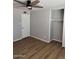 Bedroom featuring wood flooring, a ceiling fan, and closet with shelf to keep the room organized at 3006 W Stella Ln, Phoenix, AZ 85017