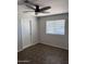 This bedroom offers a ceiling fan and a window for a comfortable and functional living space at 3006 W Stella Ln, Phoenix, AZ 85017