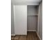 Bedroom close-up of closet with sliding door and shelf and updated flooring for a cozy and organized room at 3006 W Stella Ln, Phoenix, AZ 85017