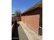 The exterior features a brick wall with a concrete walkway, gravel landscaping, and a wooden fence at 3006 W Stella Ln, Phoenix, AZ 85017