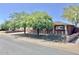 Brick home with a white fence, mature trees, offering a blend of classic charm and outdoor appeal at 3006 W Stella Ln, Phoenix, AZ 85017