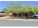 Charming brick home featuring mature trees, a white picket fence, and classic architectural details at 3006 W Stella Ln, Phoenix, AZ 85017