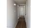 Hallway with updated wood flooring and neutral paint, offering a clean and modern aesthetic at 3006 W Stella Ln, Phoenix, AZ 85017