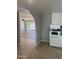 View from the kitchen, featuring tile flooring and an archway leading to the spacious living area at 3006 W Stella Ln, Phoenix, AZ 85017