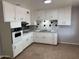 Functional kitchen featuring white cabinets, tile backsplash, and tile floors for easy maintenance at 3006 W Stella Ln, Phoenix, AZ 85017