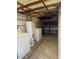 A home's utility room with shelving features a washing machine and a dryer at 3006 W Stella Ln, Phoenix, AZ 85017