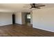 Comfortable living room with wood flooring and ceiling fan with views to the dining area and backyard at 3006 W Stella Ln, Phoenix, AZ 85017