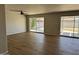Spacious living room featuring modern ceiling fan, sleek flooring, and large windows for ample natural light at 3006 W Stella Ln, Phoenix, AZ 85017