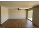 Spacious living room with wood flooring, ceiling fan, and sliding glass doors for natural light at 3006 W Stella Ln, Phoenix, AZ 85017
