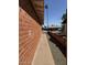Side yard with brick siding and small rock landscaping at 3006 W Stella Ln, Phoenix, AZ 85017