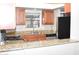 Kitchen features stone countertops, a pass-through, and stainless steel appliances at 3420 W Danbury Dr # C130, Phoenix, AZ 85053