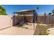 Private backyard patio with shade structure and outdoor seating area, perfect for relaxing or entertaining at 3529 W Saint Moritz Ln, Phoenix, AZ 85053