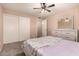 Bright bedroom with a patterned carpet, ceiling fan and bed with mirrored dresser at 3529 W Saint Moritz Ln, Phoenix, AZ 85053