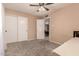 Bedroom featuring carpet, closet, ceiling fan, and neutral colored walls at 3529 W Saint Moritz Ln, Phoenix, AZ 85053