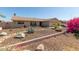 Single-story home featuring desert landscaping with natural rocks and blooming shrubs at 3529 W Saint Moritz Ln, Phoenix, AZ 85053