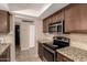 Updated kitchen with granite countertops, stainless steel appliances and a tile backsplash at 3529 W Saint Moritz Ln, Phoenix, AZ 85053
