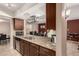 Well-lit kitchen with granite countertops, stainless steel appliances, a breakfast bar and adjacent dining area at 3529 W Saint Moritz Ln, Phoenix, AZ 85053