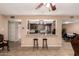 Open-concept kitchen with granite countertops, stainless steel appliances and seamless connection to the dining area at 3529 W Saint Moritz Ln, Phoenix, AZ 85053