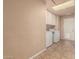 Bright laundry room with washer, dryer, cabinets and a door to the outside at 3529 W Saint Moritz Ln, Phoenix, AZ 85053