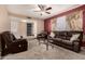 Welcoming living room with plush seating, glass table, and open access to the front entryway at 3529 W Saint Moritz Ln, Phoenix, AZ 85053