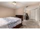 Bright main bedroom with large bed, wood furnishings, carpet, and access to an adjacent bathroom at 3529 W Saint Moritz Ln, Phoenix, AZ 85053