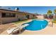 Backyard pool features a diving board, desert landscaping, and direct access to home through sliding glass doors at 3529 W Saint Moritz Ln, Phoenix, AZ 85053