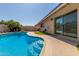 Backyard pool with deck, turf, palm trees and a covered seating area at 3529 W Saint Moritz Ln, Phoenix, AZ 85053