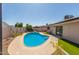 Backyard pool features desert landscaping, with views of covered patio and access to home through sliding glass doors at 3529 W Saint Moritz Ln, Phoenix, AZ 85053