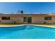 This backyard pool features stair-step access, desert landscaping, and access to home through sliding glass doors at 3529 W Saint Moritz Ln, Phoenix, AZ 85053