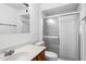 Bathroom features a vanity with wood cabinets, a toilet and a tiled shower enclosure with a glass sliding door at 414 E Westchester Dr, Tempe, AZ 85283