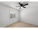 A bedroom with tile floors, ceiling fan, and a window with shuttered shades at 414 E Westchester Dr, Tempe, AZ 85283