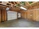 Spacious garage with an abundance of storage with built-in shelving and an automatic door at 414 E Westchester Dr, Tempe, AZ 85283