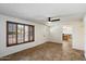 Bright living room featuring tile floors, a ceiling fan and shuttered windows bringing in plenty of natural light at 414 E Westchester Dr, Tempe, AZ 85283