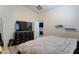 Modern bedroom with wood floors, neutral walls, and a dresser with a large television at 4199 E Citrine Rd, San Tan Valley, AZ 85143