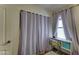 A bright bedroom features curtains by the window, and a desk with additional storage space at 4199 E Citrine Rd, San Tan Valley, AZ 85143