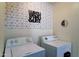 A laundry room featuring a washer and dryer with geometric patterned wallpaper at 4199 E Citrine Rd, San Tan Valley, AZ 85143