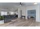 Open-concept living room featuring modern gray sofa, light wood floors, and seamless flow to kitchen at 4199 E Citrine Rd, San Tan Valley, AZ 85143