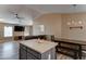 Open-concept layout with kitchen island flowing into a living room with a dining area and large TV at 4199 E Citrine Rd, San Tan Valley, AZ 85143