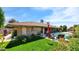 Sprawling backyard showcasing a pool, patio, and mature trees, offering a private oasis at 426 E Carol Ann Way, Phoenix, AZ 85022