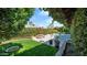 Well-maintained backyard featuring a pool and green landscaping at 426 E Carol Ann Way, Phoenix, AZ 85022