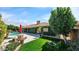 Charming backyard featuring lush landscaping, a sparkling pool, and a lovely outdoor seating area at 426 E Carol Ann Way, Phoenix, AZ 85022