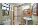Full bathroom with a shower, toilet, and pedestal sink at 426 E Carol Ann Way, Phoenix, AZ 85022
