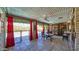 Covered patio with red drapes, furniture, and a view of the yard at 426 E Carol Ann Way, Phoenix, AZ 85022