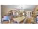Open dining area showcasing a large table, elegant chandelier, and seamless flow to living spaces at 426 E Carol Ann Way, Phoenix, AZ 85022