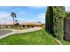 Expansive front yard with mature landscaping, showcasing the home's charming exterior and long driveway at 426 E Carol Ann Way, Phoenix, AZ 85022