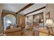 Cozy living room featuring hardwood floors, exposed wood beams, and ample natural light at 426 E Carol Ann Way, Phoenix, AZ 85022