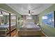 Main bedroom with a large bed and a mirrored closet with ceiling fan at 426 E Carol Ann Way, Phoenix, AZ 85022