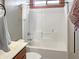 Clean and simple white tiled bathroom with tub and shower combination at 45726 W Long Way, Maricopa, AZ 85139