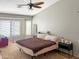 Relaxing bedroom with a large bed, ceiling fan, and natural light at 45726 W Long Way, Maricopa, AZ 85139